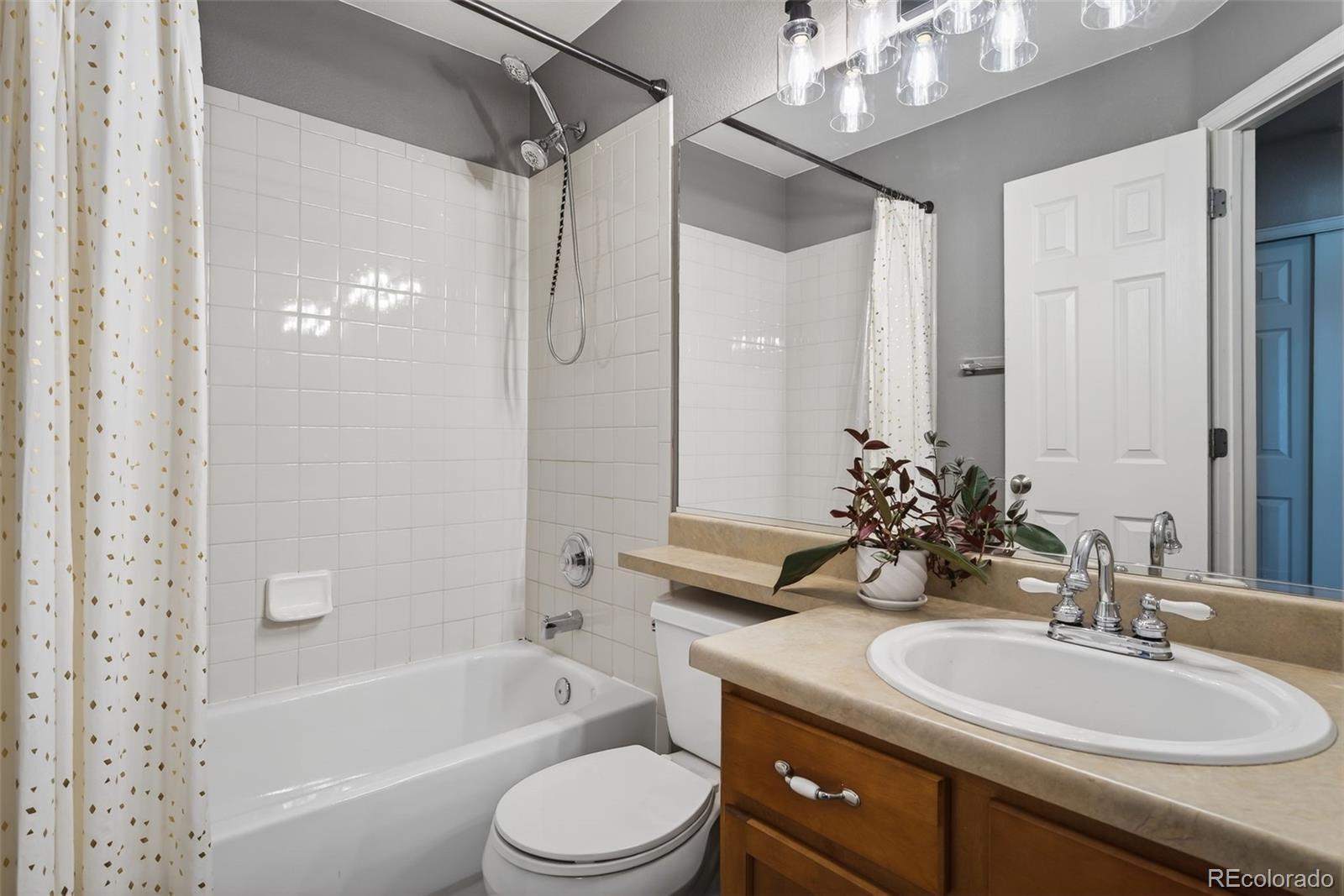 6737 Thistle Ridge Avenue Firestone, CO 80504 - Photo 22 of 39 a bathroom with a sink a toilet a mirror a bathtub and shower