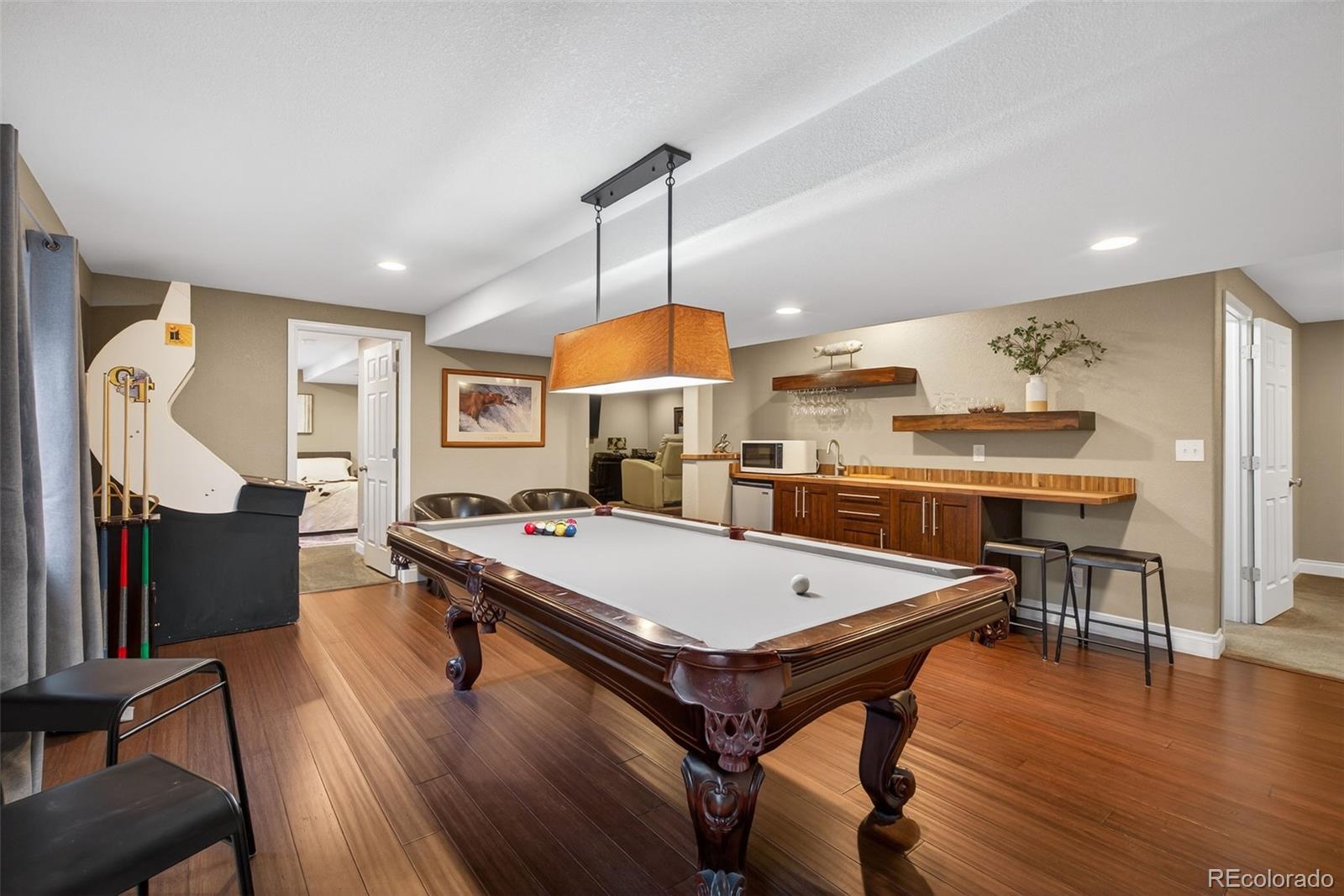 6737 Thistle Ridge Avenue Firestone, CO 80504 - Photo 24 of 39 a room with stainless steel appliances kitchen island granite countertop dining table chairs and a large window