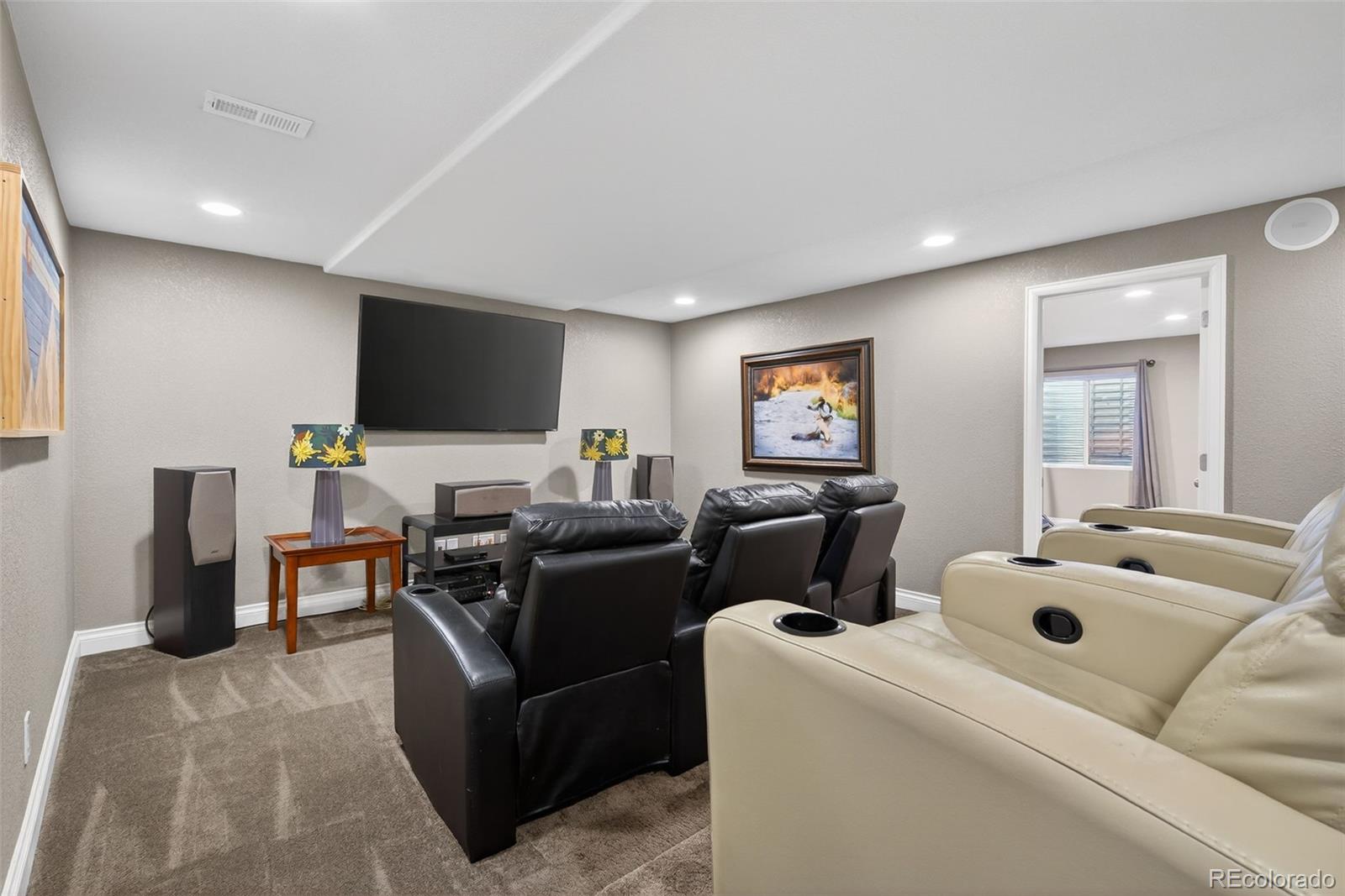 6737 Thistle Ridge Avenue Firestone, CO 80504 - Photo 26 of 39 a living room with furniture and a flat screen tv