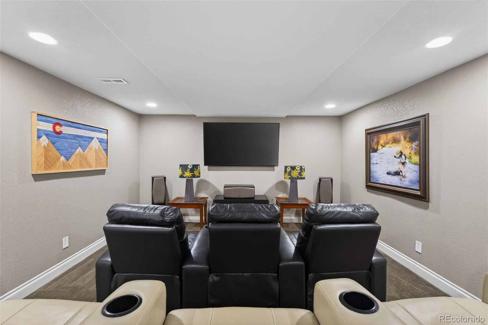 6737 Thistle Ridge Avenue Firestone, CO 80504 - Photo 27 of 39 a living room with furniture a rug and a flat screen tv