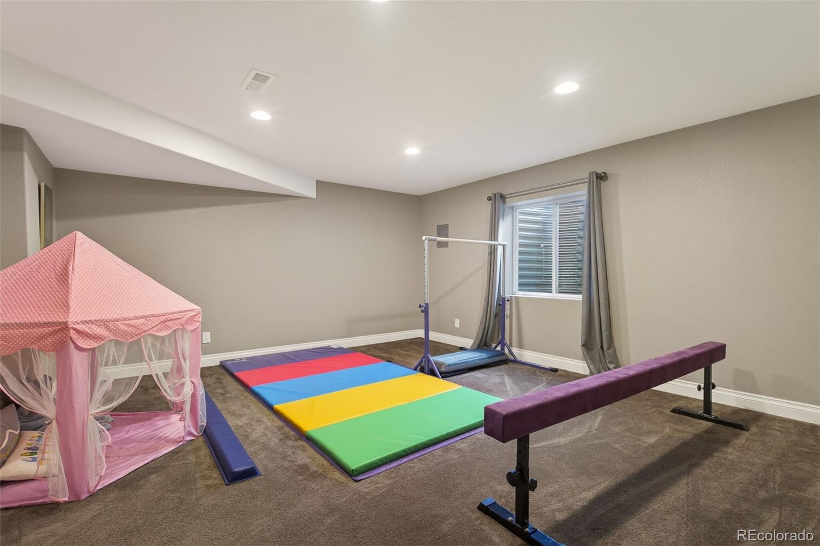 6737 Thistle Ridge Avenue Firestone, CO 80504 - Photo 30 of 39 a living room with a pool table and windows