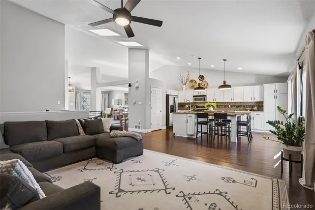 a living room with furniture and kitchen view