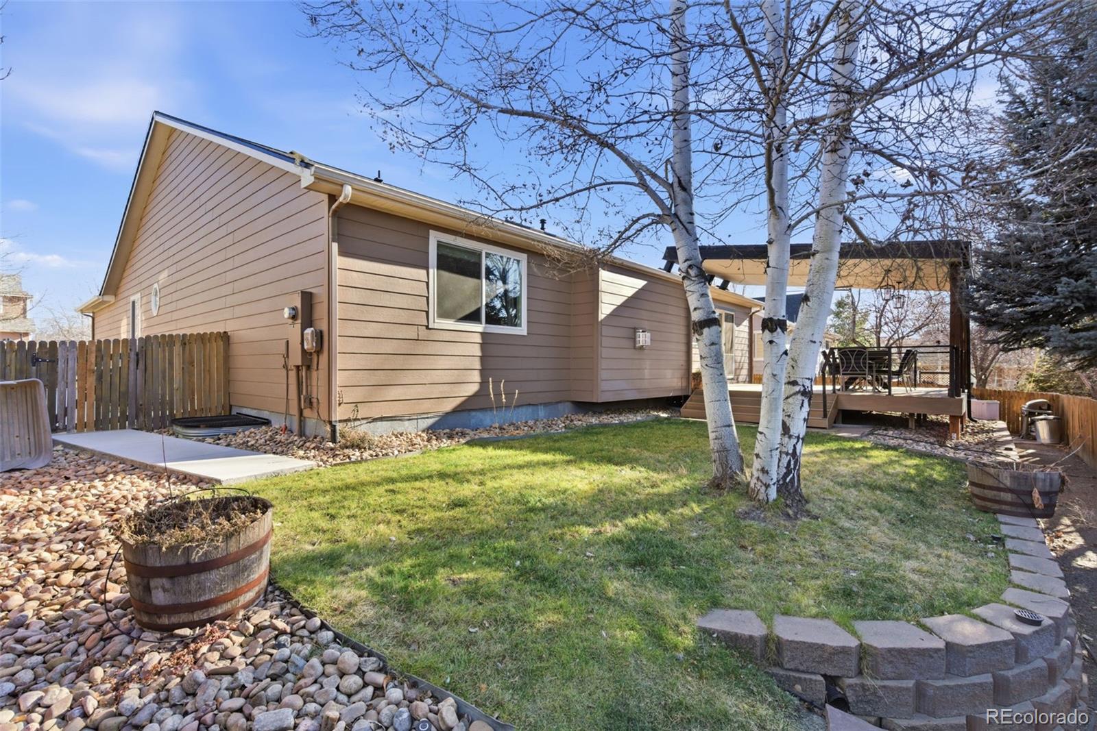 6737 Thistle Ridge Avenue Firestone, CO 80504 - Photo 35 of 39 a house view with a backyard space