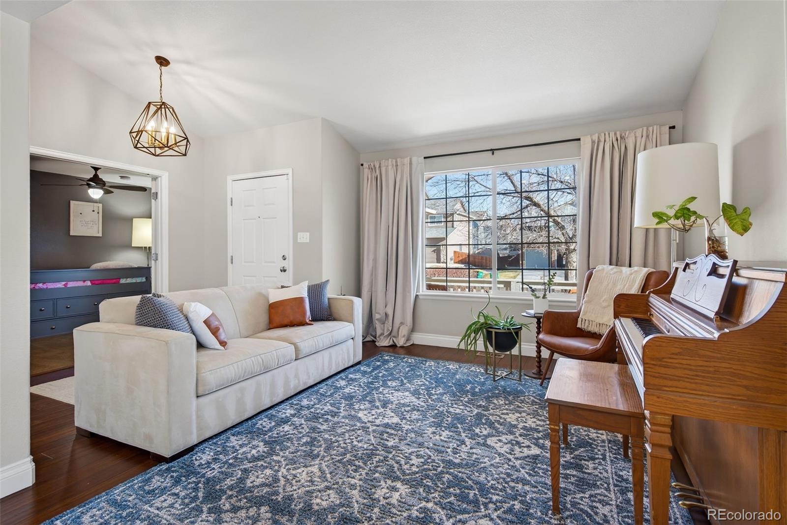 6737 Thistle Ridge Avenue Firestone, CO 80504 - Photo 4 of 39 a living room with furniture a dining table and a large window