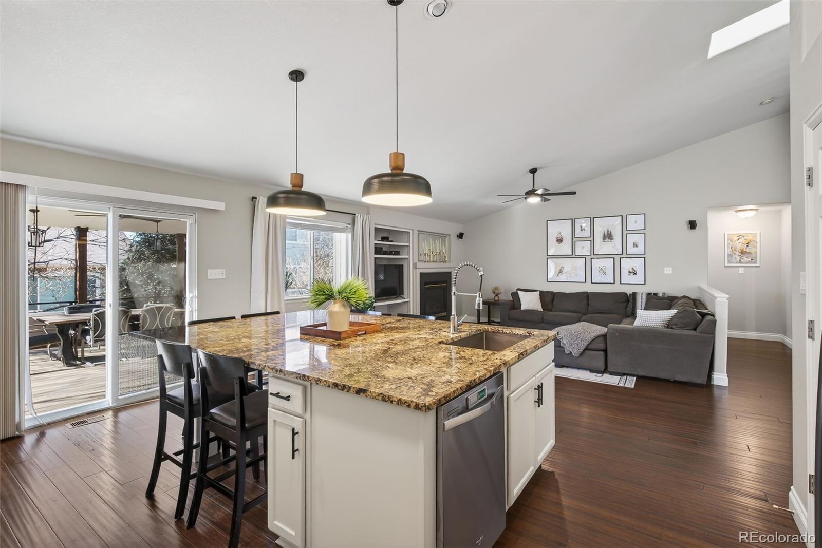 6737 Thistle Ridge Avenue Firestone, CO 80504 - Photo 8 of 39 a kitchen that has a table chairs and wooden floor