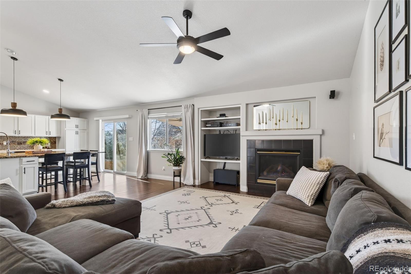 6737 Thistle Ridge Avenue Firestone, CO 80504 - Photo 9 of 39 a living room with furniture ceiling fan and a fireplace