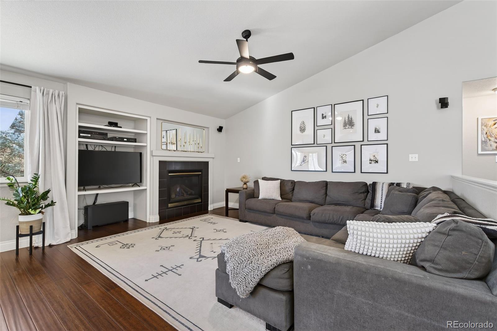 6737 Thistle Ridge Avenue Firestone, CO 80504 - Photo 10 of 39 a living room with furniture fireplace and flat screen tv