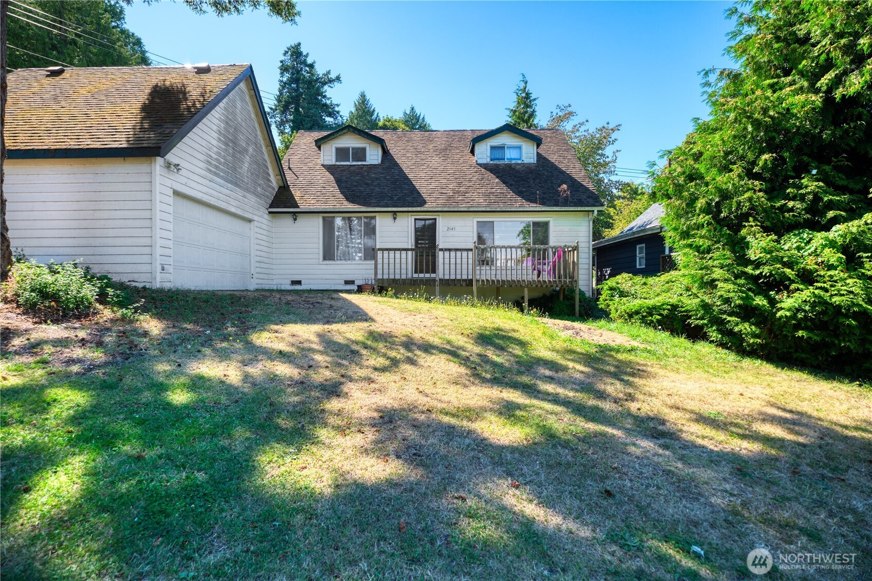 2145 Fir Street Point Roberts, WA 98281 - Photo 3 of 36 a front view of a house with a yard and garage
