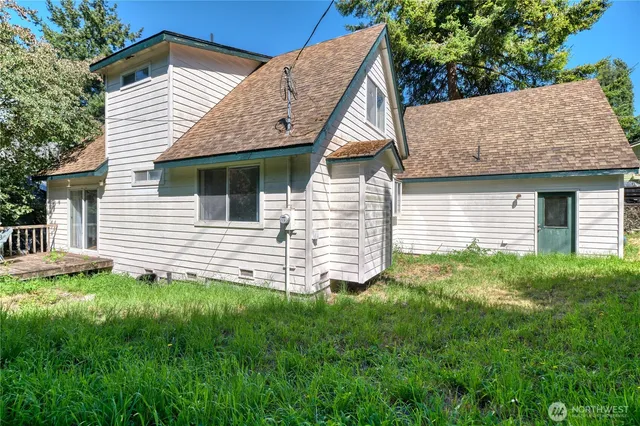 a view of a house with a yard and deck