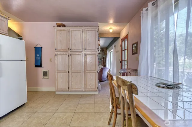 a view of kitchen with furniture and refrigerator
