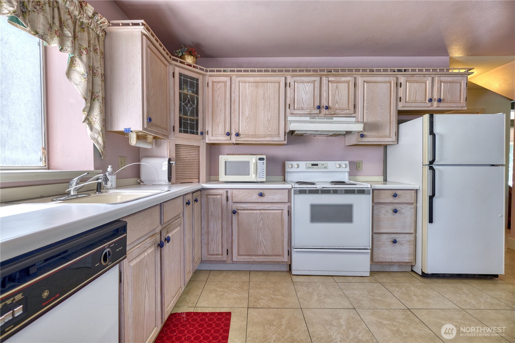 2145 Fir Street Point Roberts, WA 98281 - Photo 9 of 36 a kitchen with white cabinets and white appliances