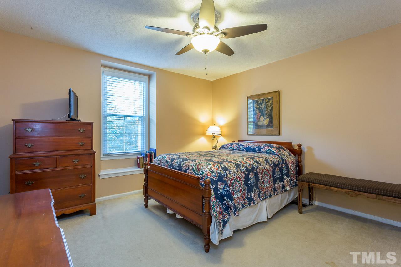 3901 Pin Oak Road Raleigh, NC 27604 - Photo 11 of 24 a bedroom with a bed and a chandelier