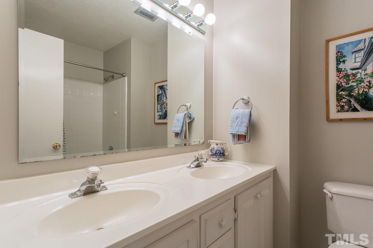 3901 Pin Oak Road Raleigh, NC 27604 - Photo 13 of 24 a bathroom with a sink and a mirror