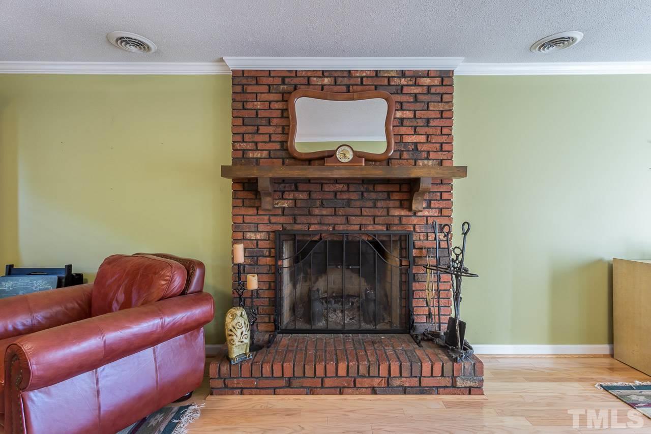 3901 Pin Oak Road Raleigh, NC 27604 - Photo 16 of 24 a living room with furniture and a fireplace