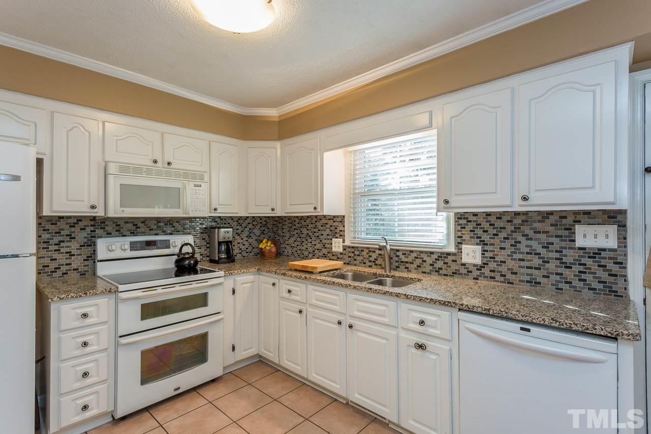 3901 Pin Oak Road Raleigh, NC 27604 - Photo 4 of 24 a kitchen with appliances cabinets and a sink