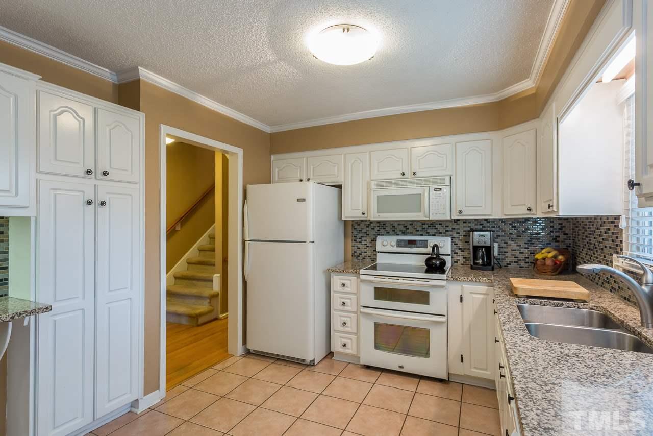 3901 Pin Oak Road Raleigh, NC 27604 - Photo 5 of 24 a kitchen with a refrigerator sink and cabinets