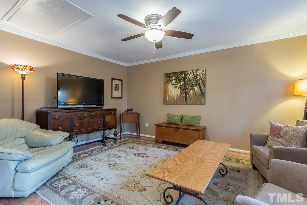 3901 Pin Oak Road Raleigh, NC 27604 - Photo 8 of 24 a living room with furniture and a flat screen tv