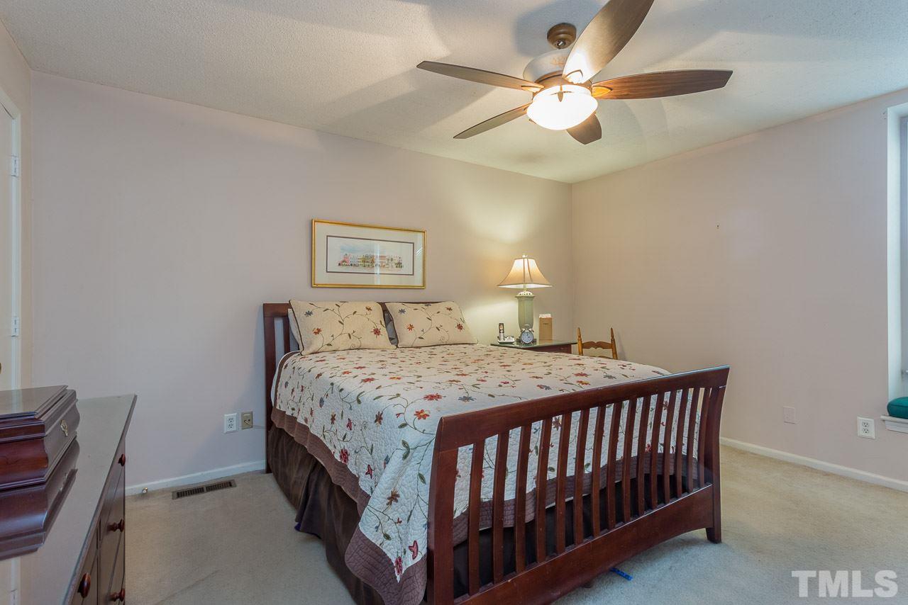3901 Pin Oak Road Raleigh, NC 27604 - Photo 9 of 24 a bedroom with a bed and a ceiling fan