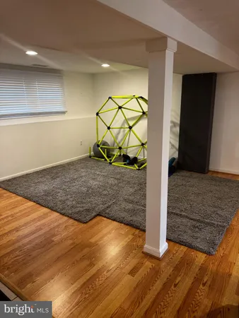 a view of a livingroom with wooden floor and entryway