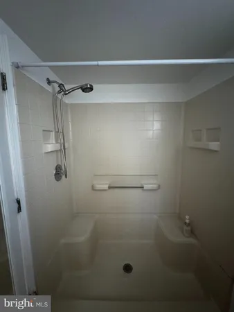a bathroom with a glass shower door