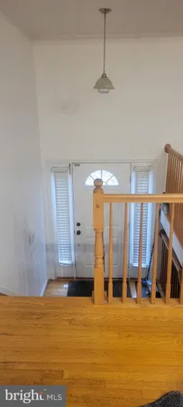 a view of a room with furniture and floor to ceiling window