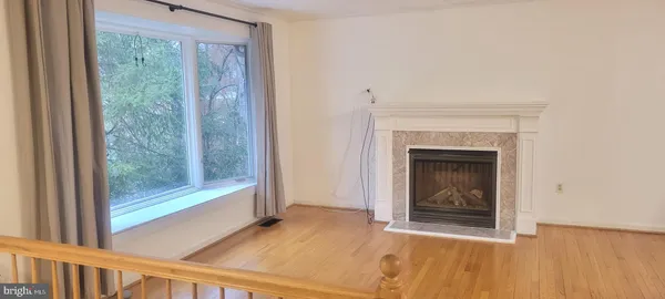 a view of a livingroom with a fireplace and window