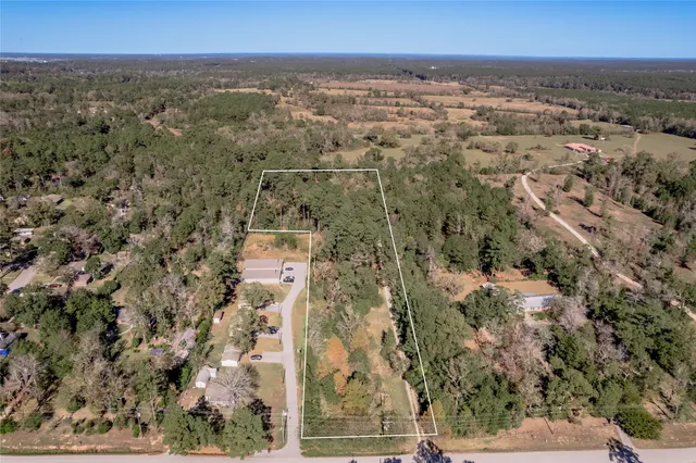 an aerial view of residential house and outdoor space