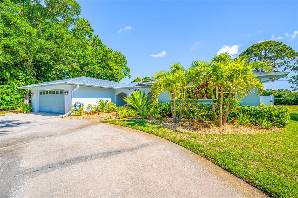656 Mehlenbacher Road Belleair, FL 33756 - Photo 44 of 49 a front view of a house with garden