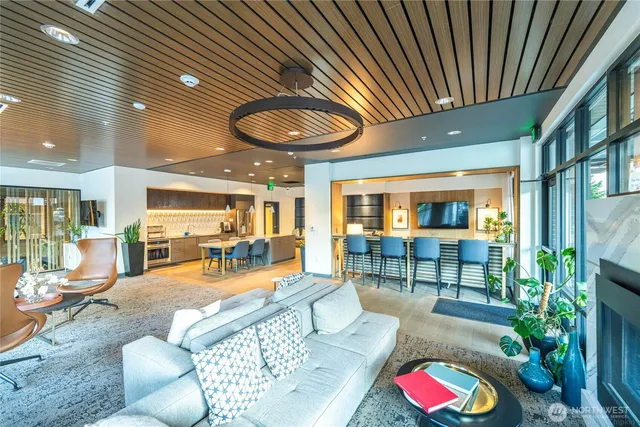 a kitchen with stainless steel appliances granite countertop a sink stove and living room view