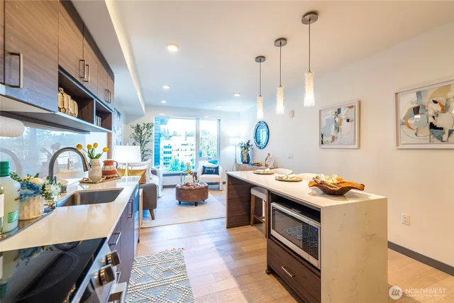 a living room with furniture and kitchen view