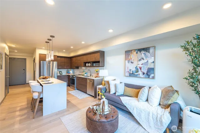 a living room with furniture and a wooden floor