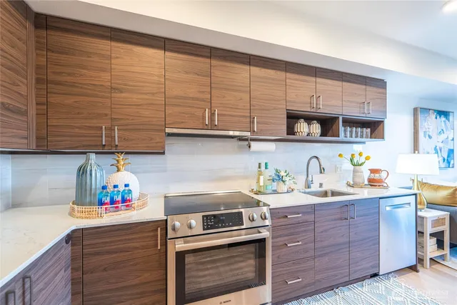 a kitchen with stainless steel appliances kitchen island granite countertop a sink and cabinets