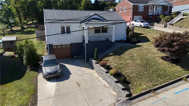 a view of a backyard with a small cabin and wooden fence