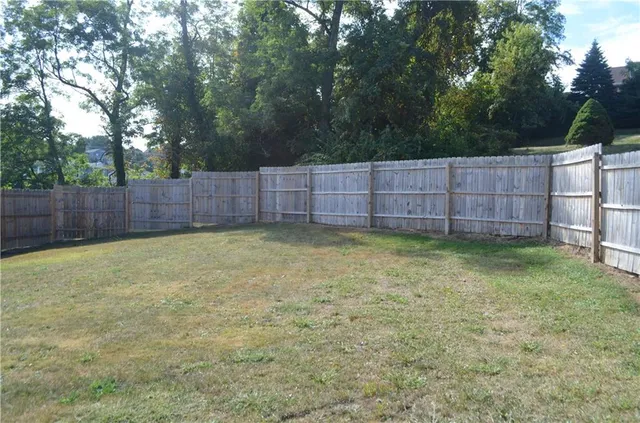 a view of a white house with a yard