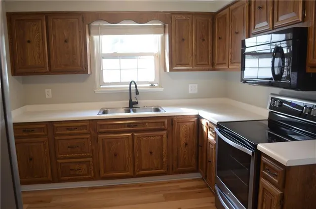 a kitchen with sink cabinets and window