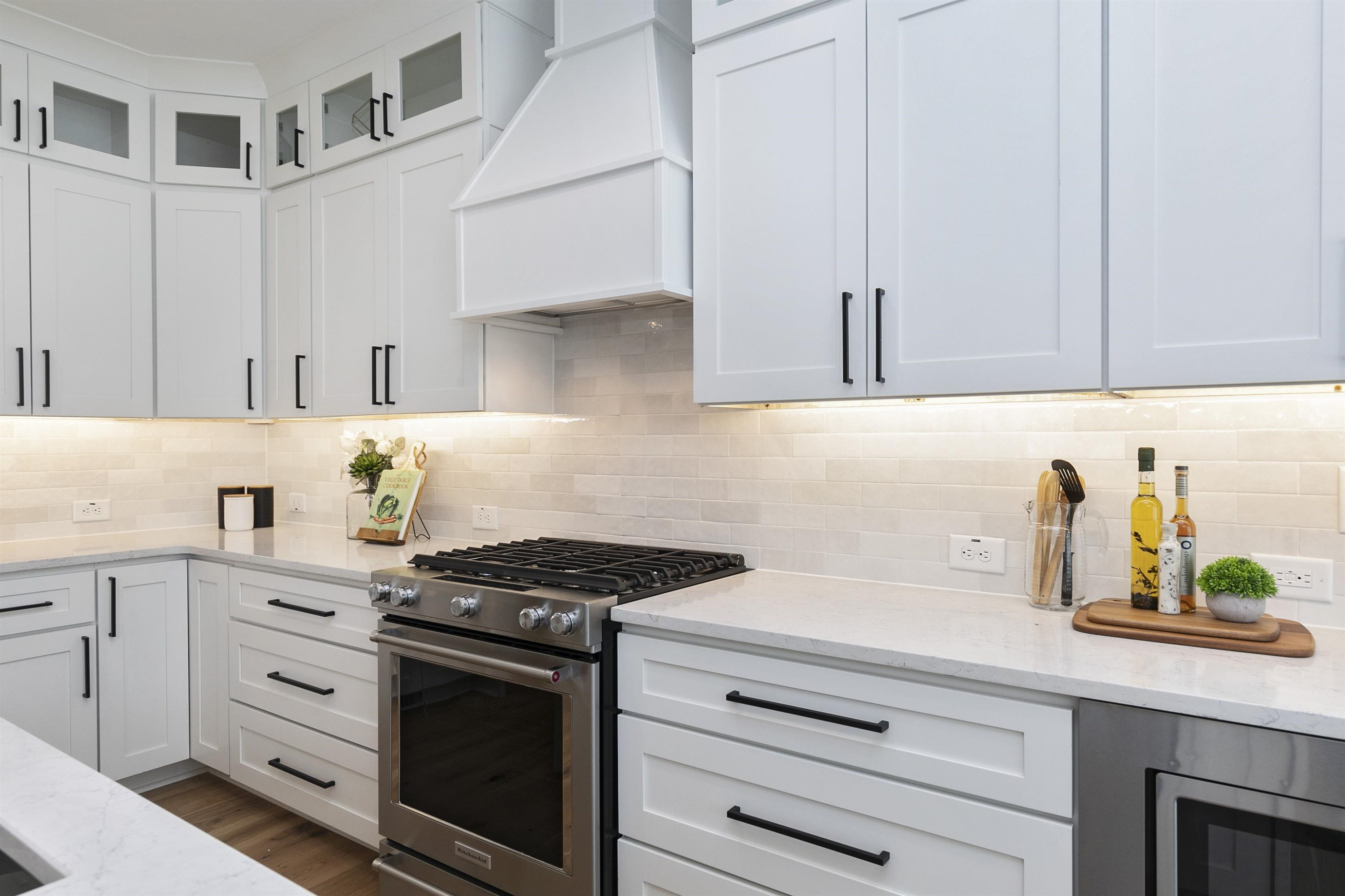 114 Summit Avenue Raleigh, NC 27603 - Photo 13 of 62 a kitchen with granite countertop white cabinets and white appliances