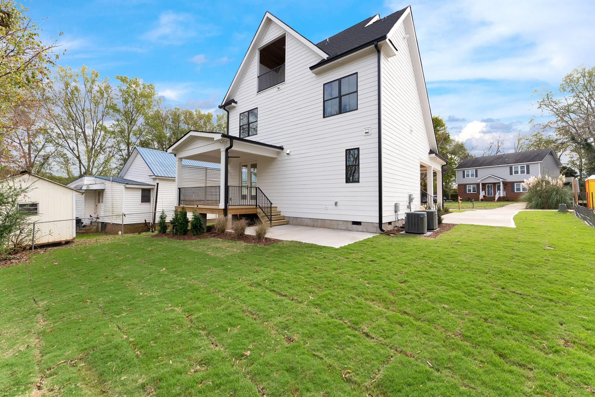 114 Summit Avenue Raleigh, NC 27603 - Photo 49 of 62 a view of a white house in front of a big yard with large trees