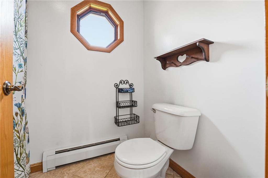 10486 Mohawk Road Conneaut Lake, PA 16316 - Photo 23 of 35 a white toilet sitting next to a shower curtain
