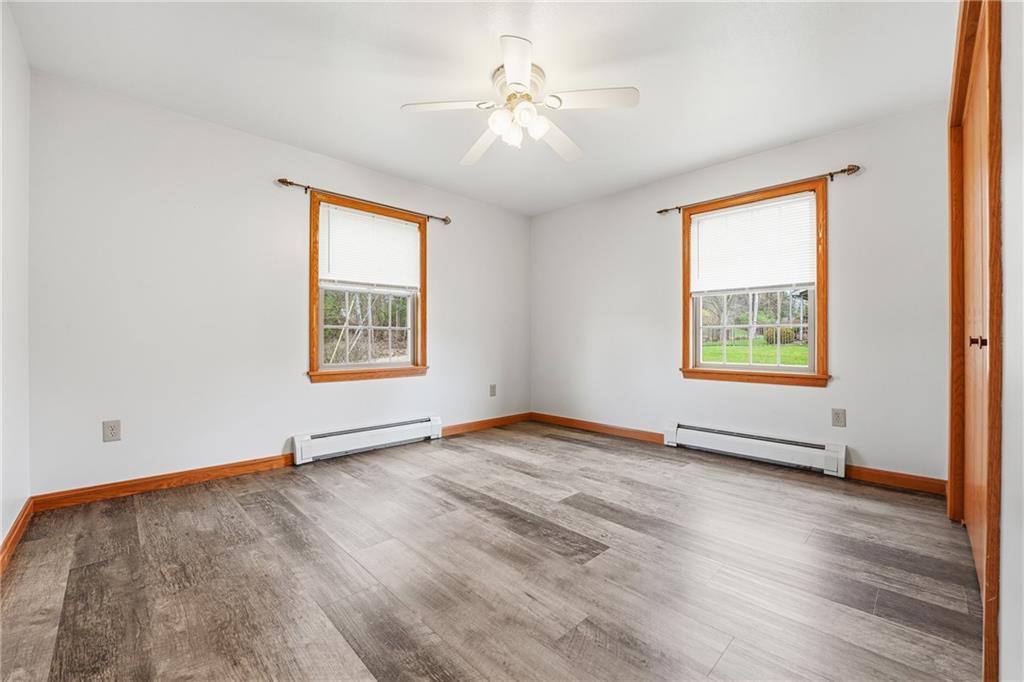 10486 Mohawk Road Conneaut Lake, PA 16316 - Photo 25 of 35 an empty room with windows and ceiling fan