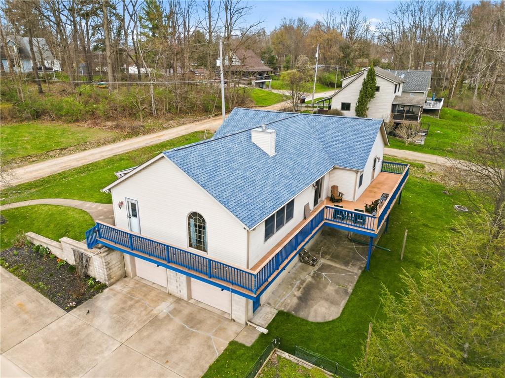 10486 Mohawk Road Conneaut Lake, PA 16316 - Photo 3 of 35 an aerial view of a house with a yard table and chairs