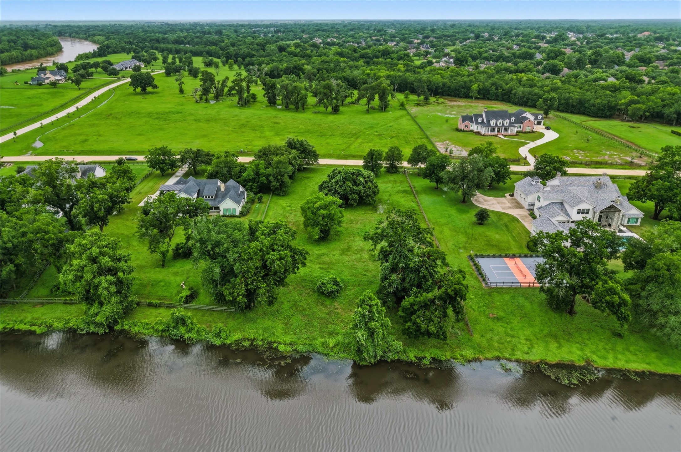 0 Riverlake Road Fulshear, TX 77441 - Photo 42 of 47 This breathtaking aerial perspective highlights the property's coveted riverfront location and remarkable setting among elegant custom estates.