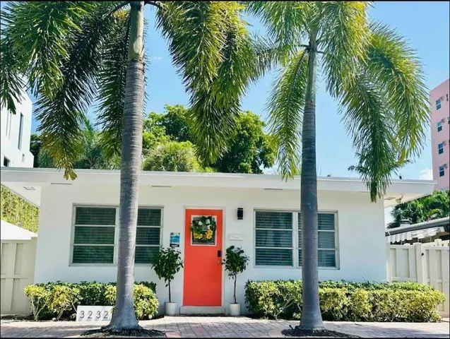 a view of a house with a tree in front