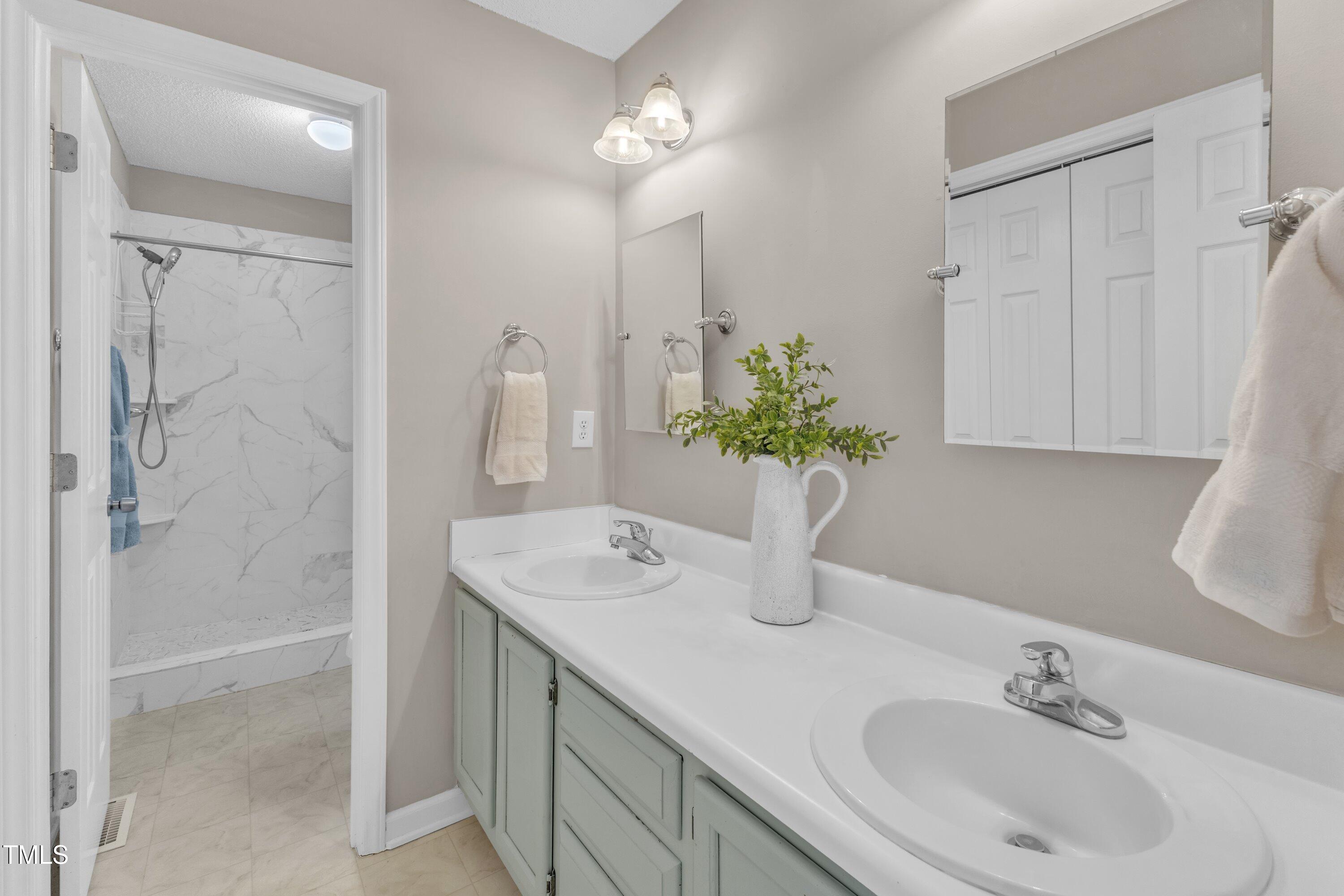 4533 Whistling Way Raleigh, NC 27616 - Photo 21 of 25 Owners Bathroom has double vanity, drawer stack and LARGE linen closet behind door entry