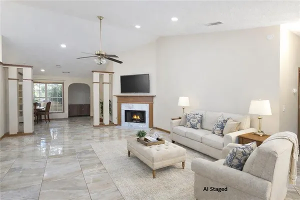 a living room with furniture a fireplace and a flat screen tv