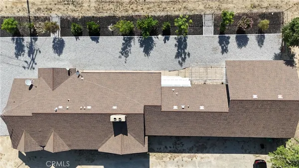 an aerial view of a house with a yard