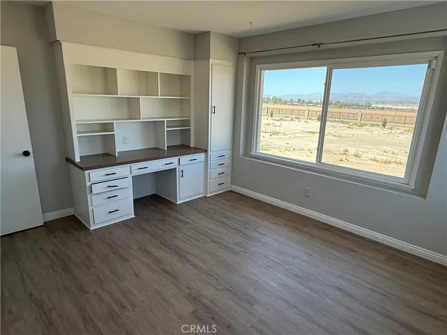 a room with a wooden floor and a window