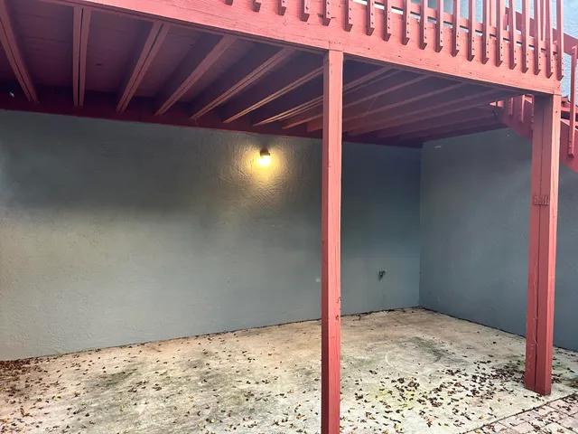a view of balcony with wooden floor and fence
