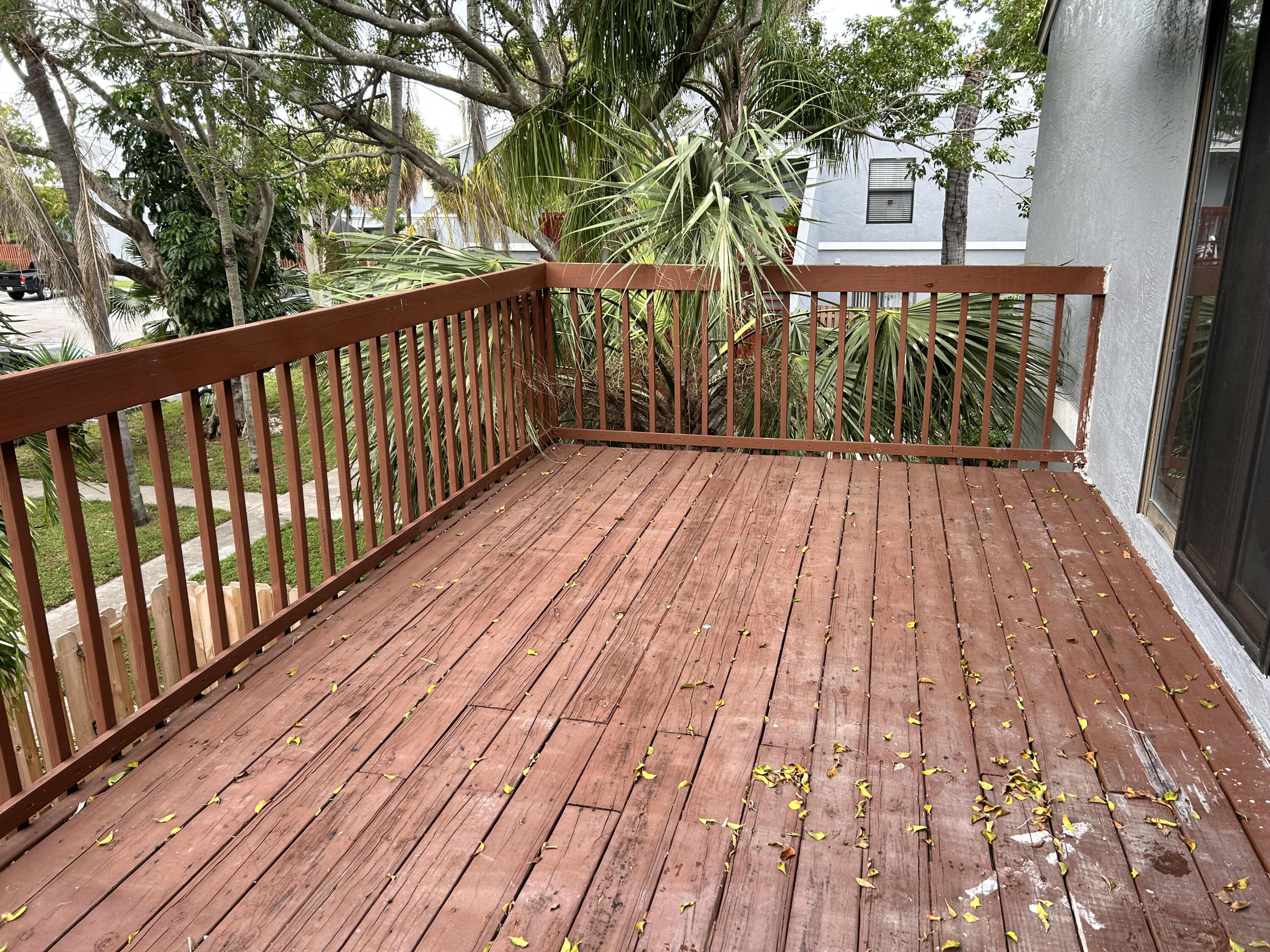 23 Crossings Circle, Unit E Boynton Beach, FL 33435 - Photo 16 of 19 a view of balcony with wooden floor and fence