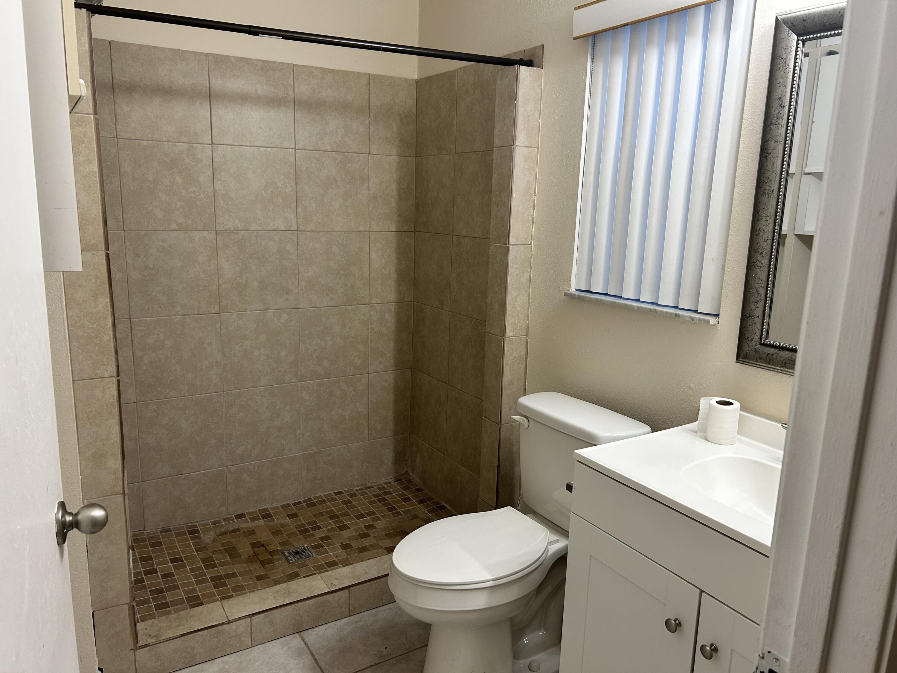23 Crossings Circle, Unit E Boynton Beach, FL 33435 - Photo 5 of 19 a bathroom with a sink and a toilet