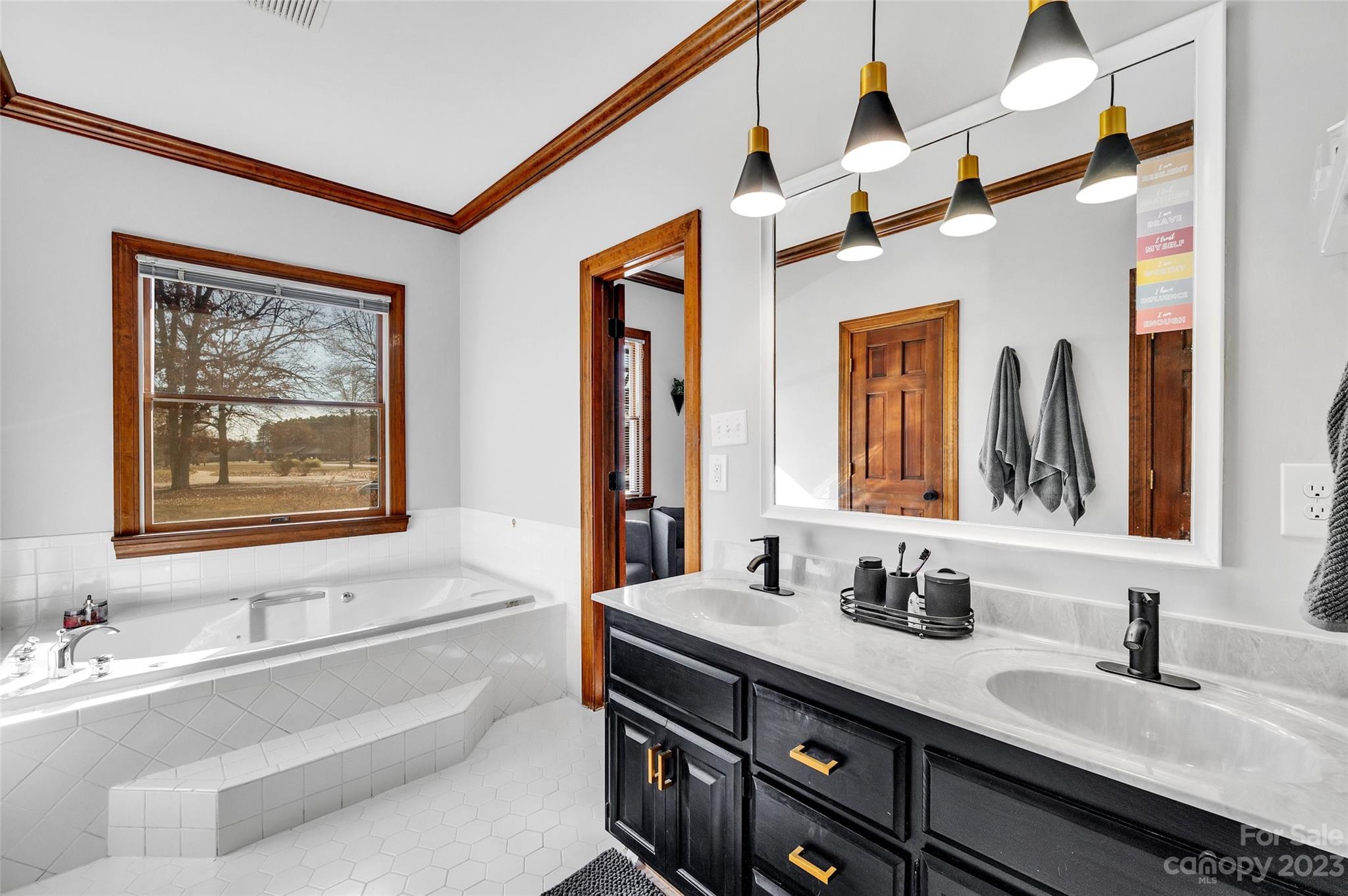 700 West Zion Church Road Shelby, NC 28150 - Photo 21 of 45 a bathroom with double vanity sinks a large mirror and a window